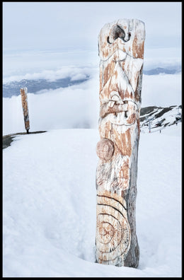 Snow-Covered Totem Poles Poster